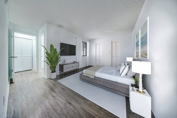 Bedroom with contemporary decor and large window in Cielo Point Apartments