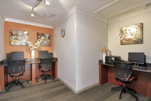 Clubhouse business center with modern workstations at Cielo Point Apartments, offering luxury living and workspaces