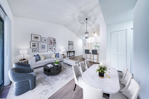 Spacious living room with modern decor and large windows at Cielo Point Apartments, offering luxury living in a vibrant community