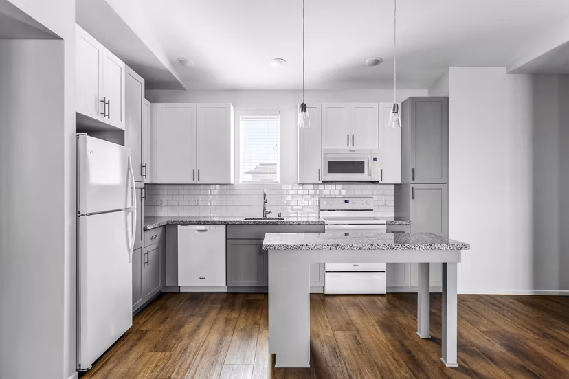 Kitchen with stainless steel appliances and quartz countertops at The Element Apartments