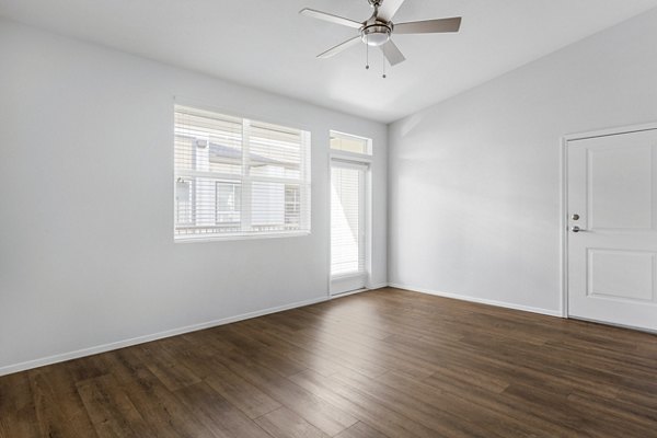 Living room with modern decor and natural light at The Element Apartments