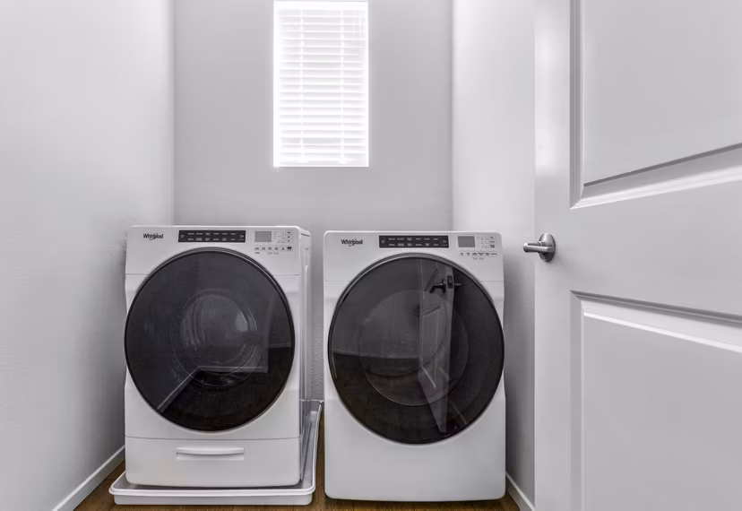 Laundry room equipped with modern washers and dryers at The Element Apartments, ideal for convenient and efficient laundry care