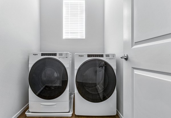 Laundry room equipped with modern washers and dryers at The Element Apartments, ideal for convenient and efficient laundry care
