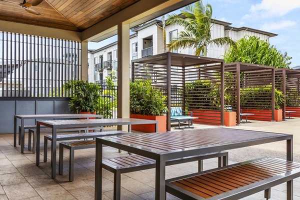 The Element Apartments: Stylish patio with modern seating and lush greenery
