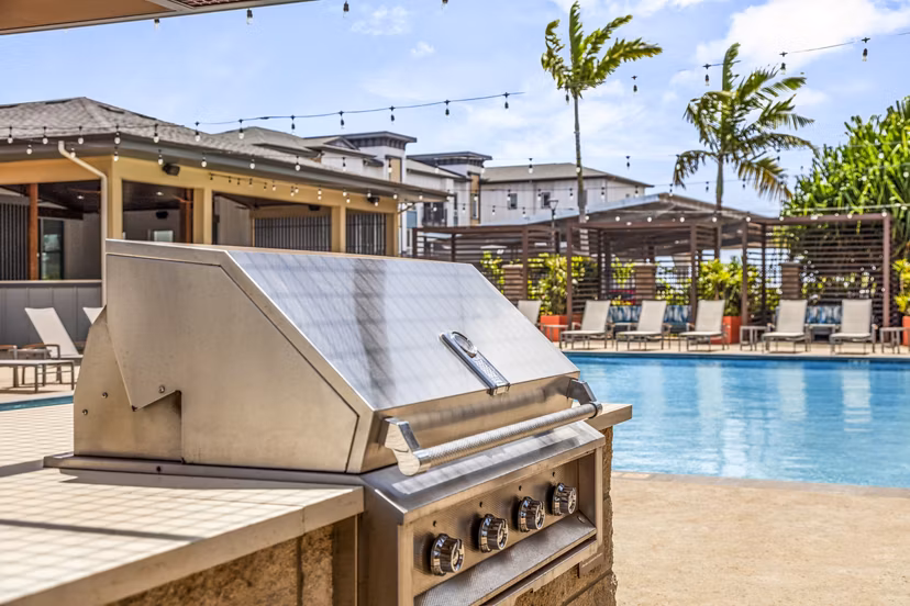 Outdoor grill area with modern seating at The Element Apartments