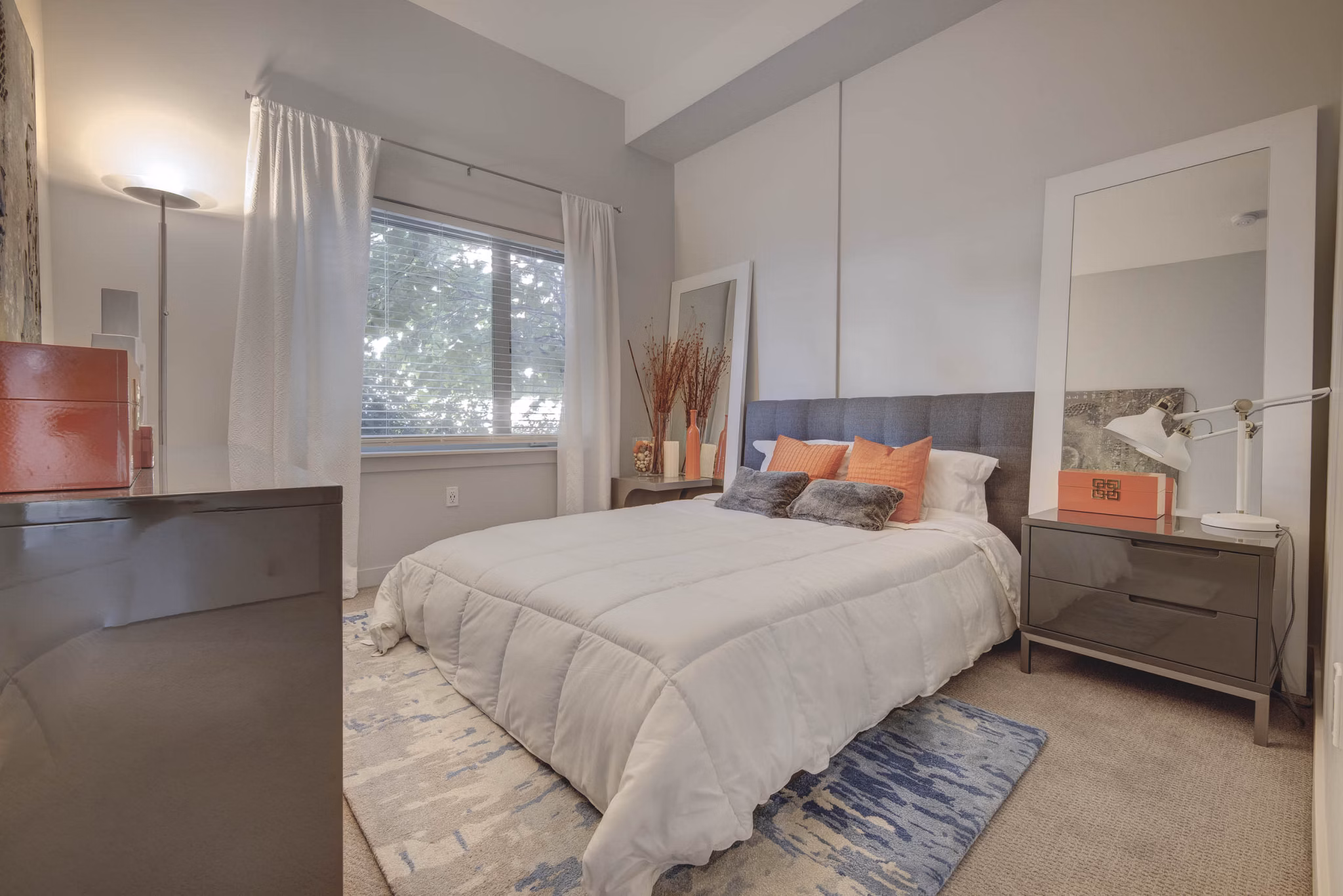 Spacious bedroom with plush bedding and modern decor at The Calo Apartments in luxury Greystar community