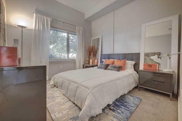 Spacious bedroom with plush bedding and modern decor at The Calo Apartments in luxury Greystar community