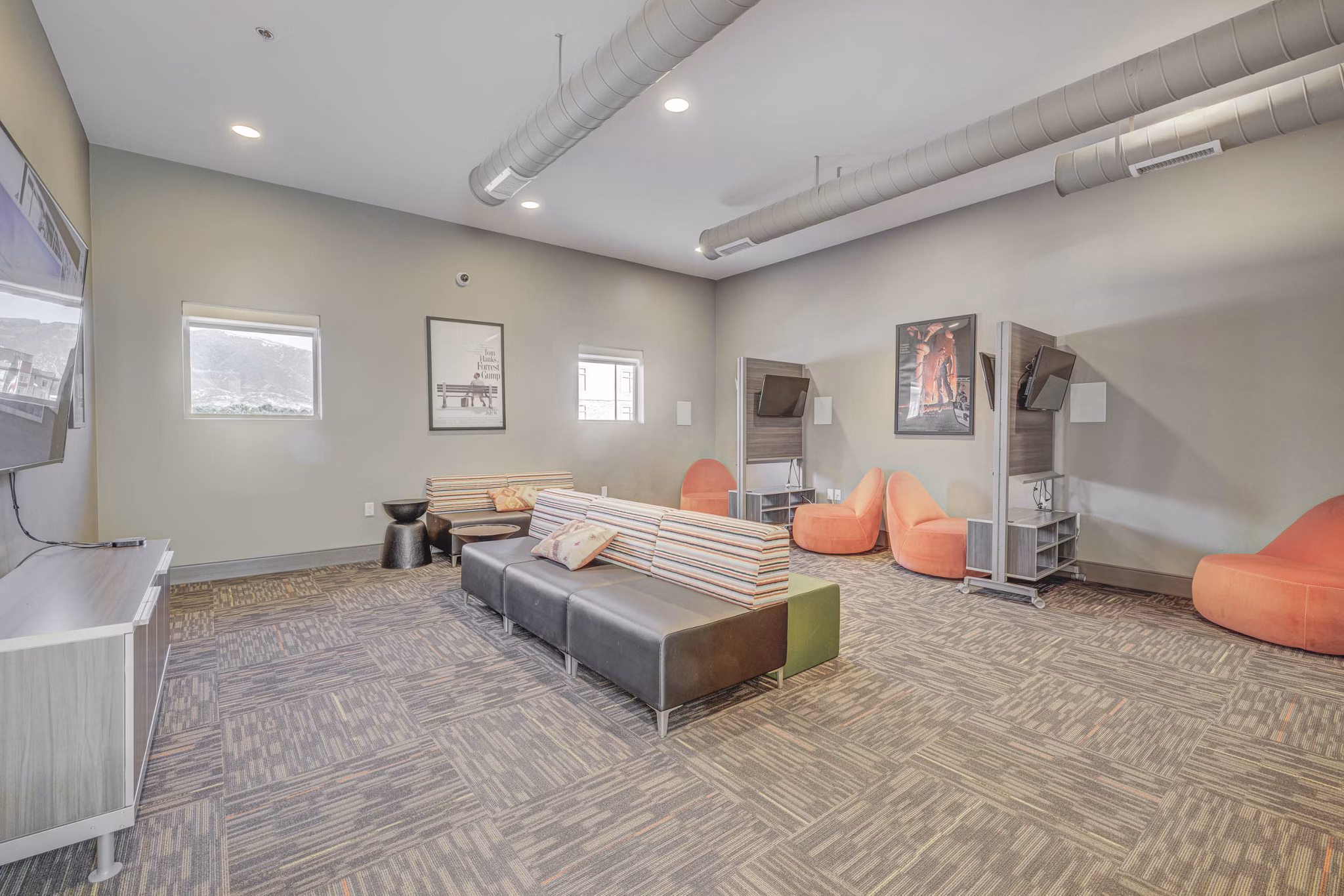 Modern clubhouse with cozy seating areas at The Calo Apartments, offering a luxurious space for residents to relax and socialize