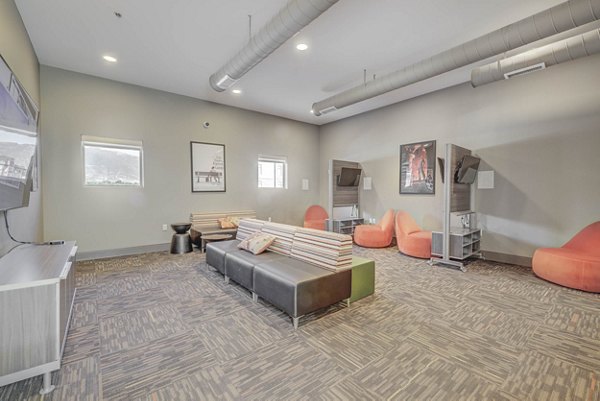 Modern clubhouse with cozy seating areas at The Calo Apartments, offering a luxurious space for residents to relax and socialize