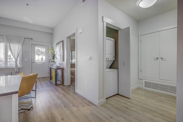 Modern kitchen with stainless steel appliances in The Calo Apartments