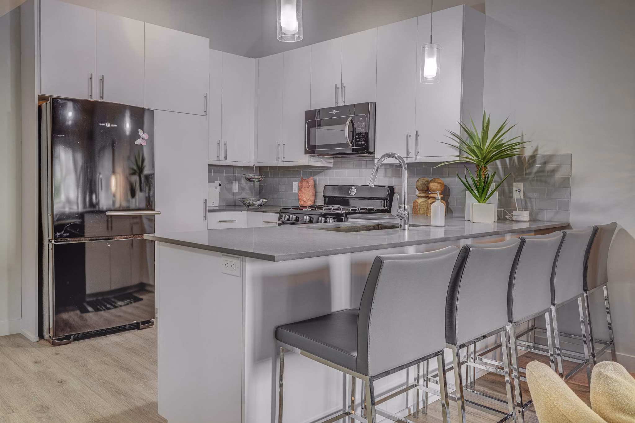 Modern kitchen featuring stainless steel appliances and granite countertops in The Calo Apartments