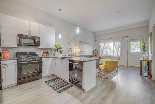 Modern kitchen with stainless steel appliances at The Calo Apartments, perfect for luxury living in a Greystar community