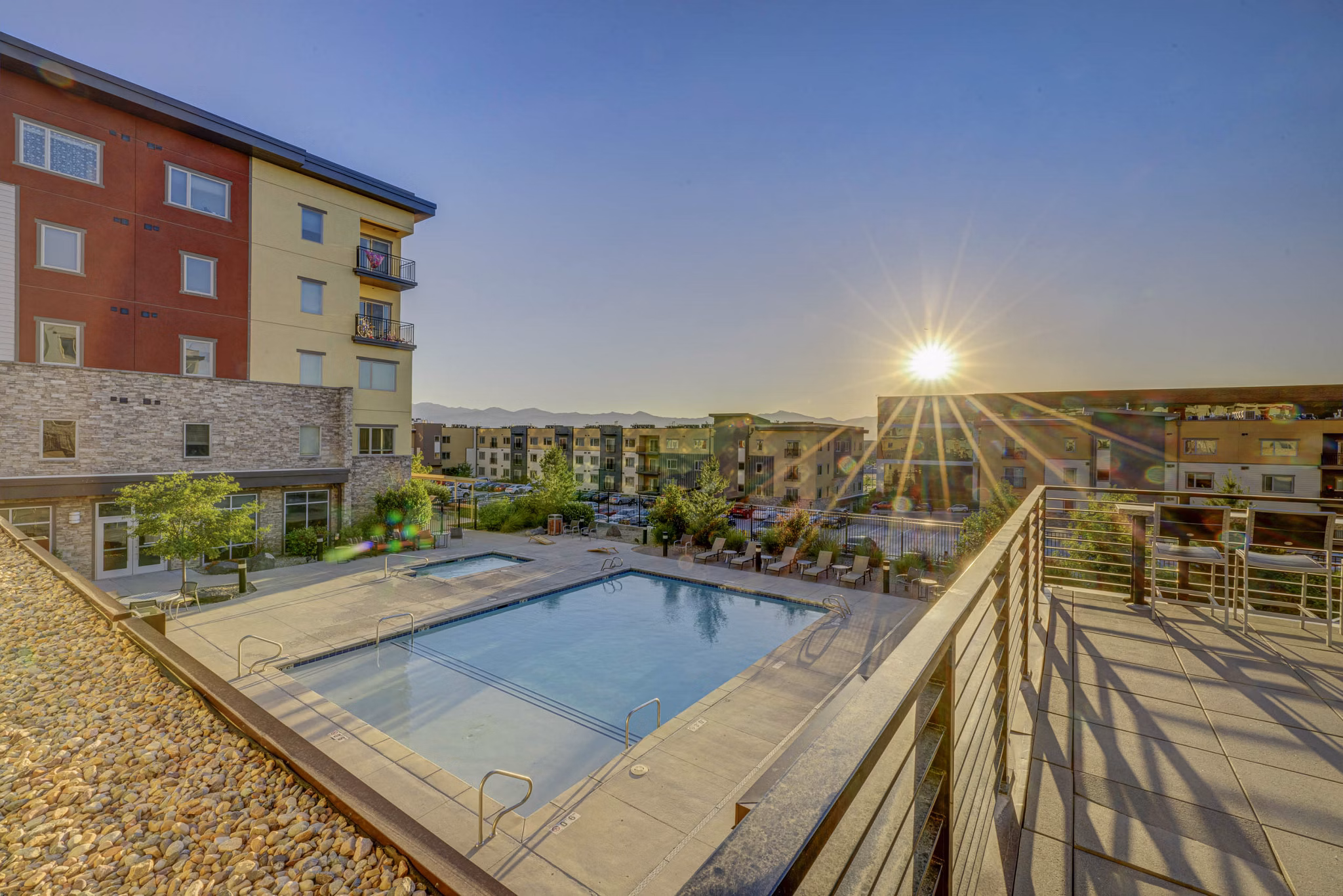 Luxury pool at The Calo Apartments featuring sun loungers and cabanas