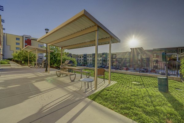 Courtyard with lush gardens and seating areas at The Calo Apartments, a luxury living community