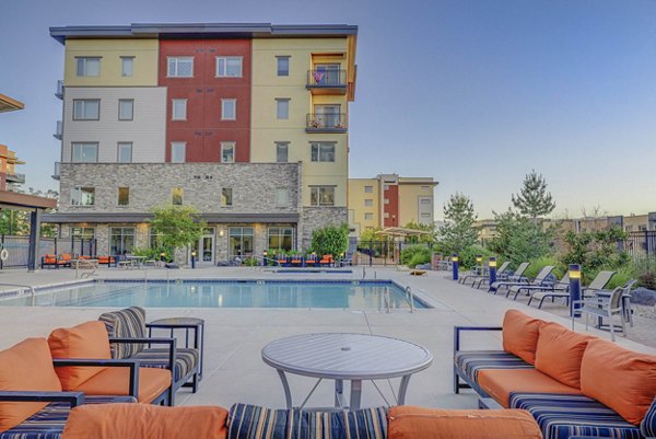 Chic outdoor patio at The Calo Apartments, featuring stylish seating and lush greenery