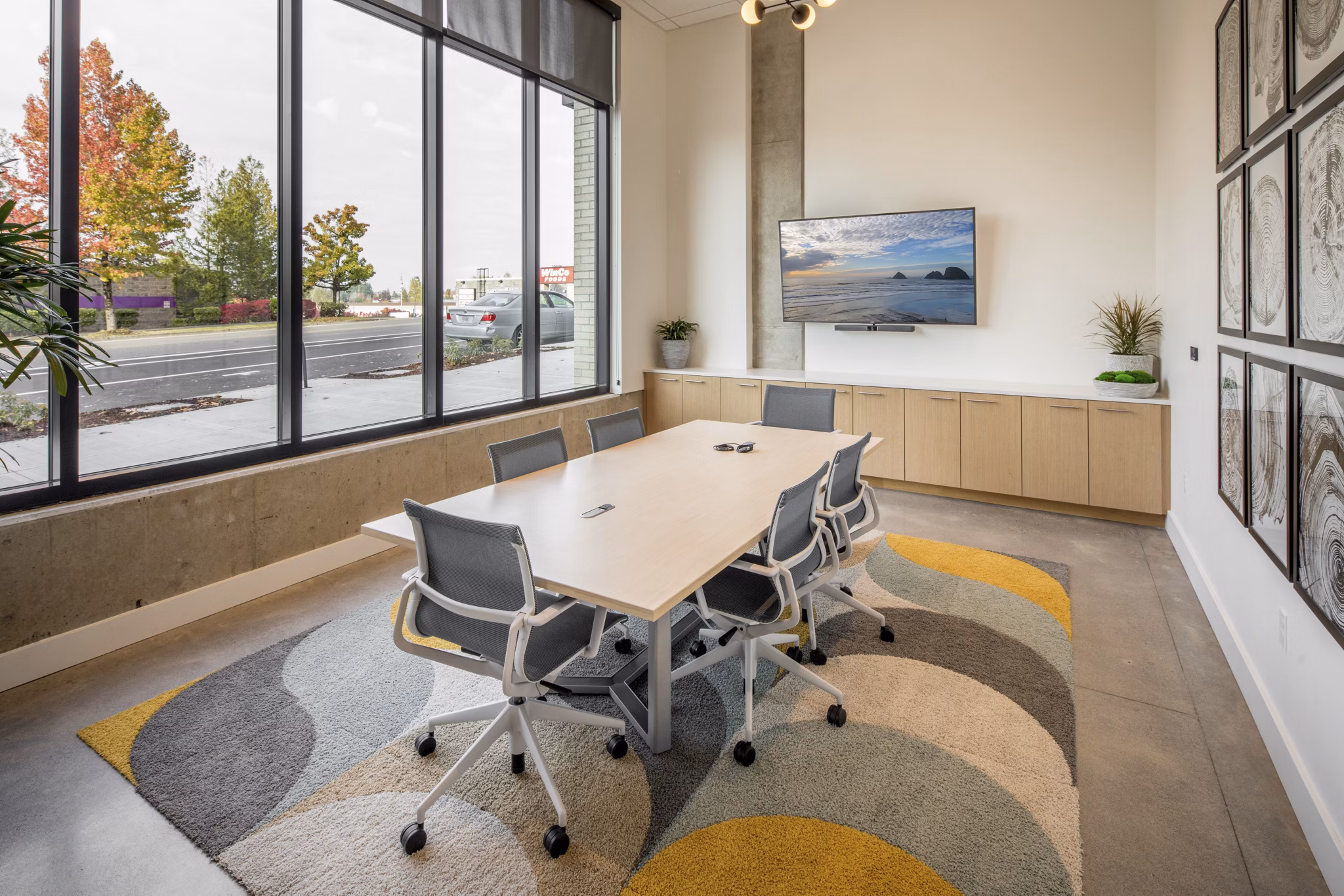 Meeting facility with modern seating and presentation screen at The Overland Apartments