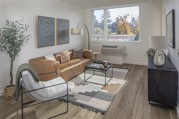 Spacious living room with modern decor at The Overland Apartments