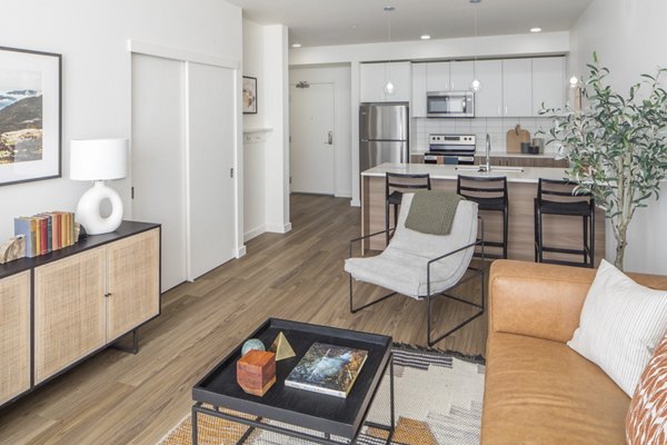 Modern living room with sleek furniture and large windows in The Overland Apartments