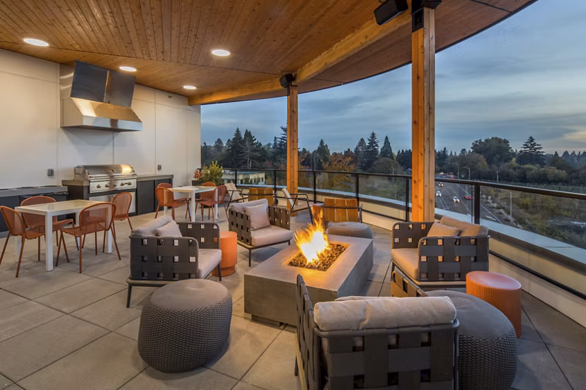 Cozy fire pit area with seating at The Overland Apartments, perfect for outdoor relaxation