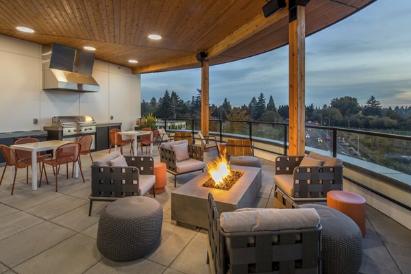 Cozy fire pit area with seating at The Overland Apartments, perfect for outdoor relaxation