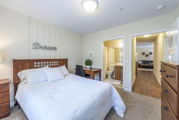 Cozy bedroom with modern decor at Campus View Apartments, perfect for comfortable living near student facilities