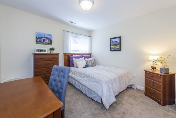 Cozy bedroom with modern decor at Campus View Apartments