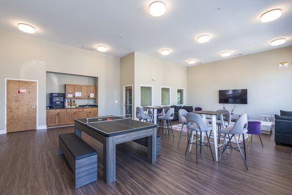 Game room with pool table and modern decor at Campus View Apartments clubhouse
