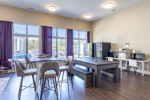 Clubhouse game room featuring pool table and lounge seating at Campus View Apartments