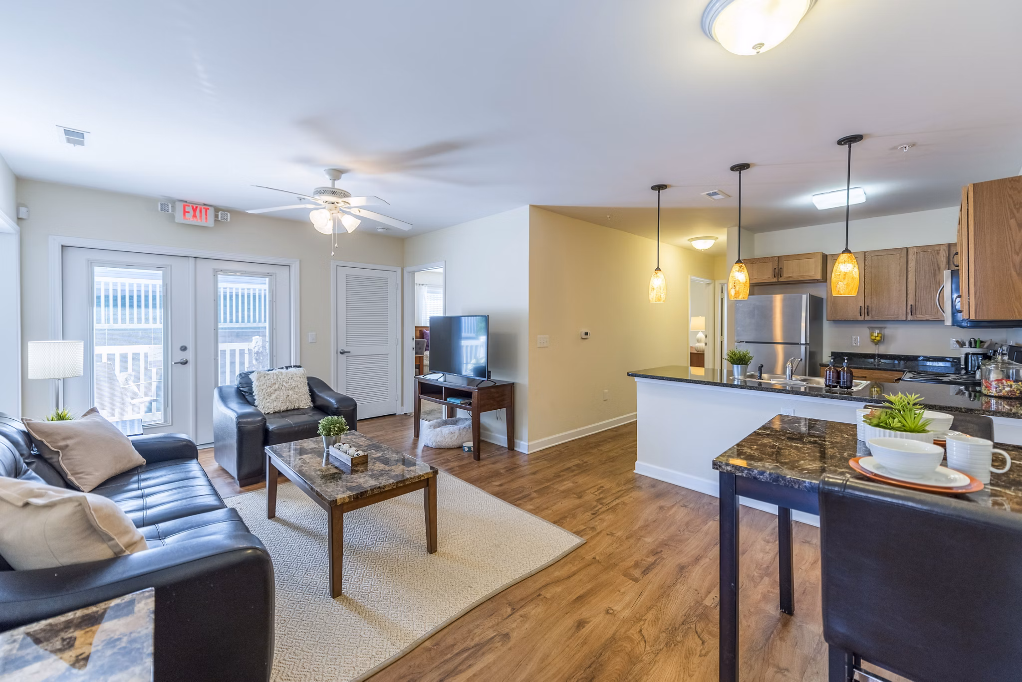 Living room with modern decor and large windows at Campus View Apartments offering comfort and style in a vibrant community setting