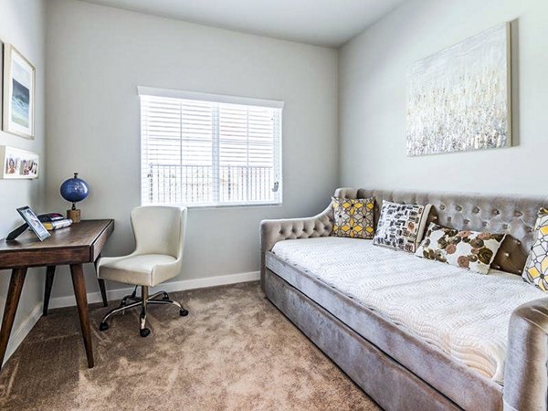 Spacious bedroom with home office space at Sereno Apartments, offering comfort and functionality for luxury living