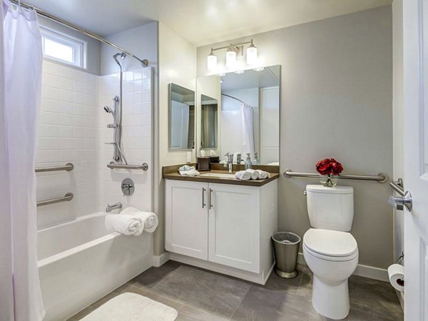 Modern bathroom with marble countertops and elegant fixtures at Sereno Apartments