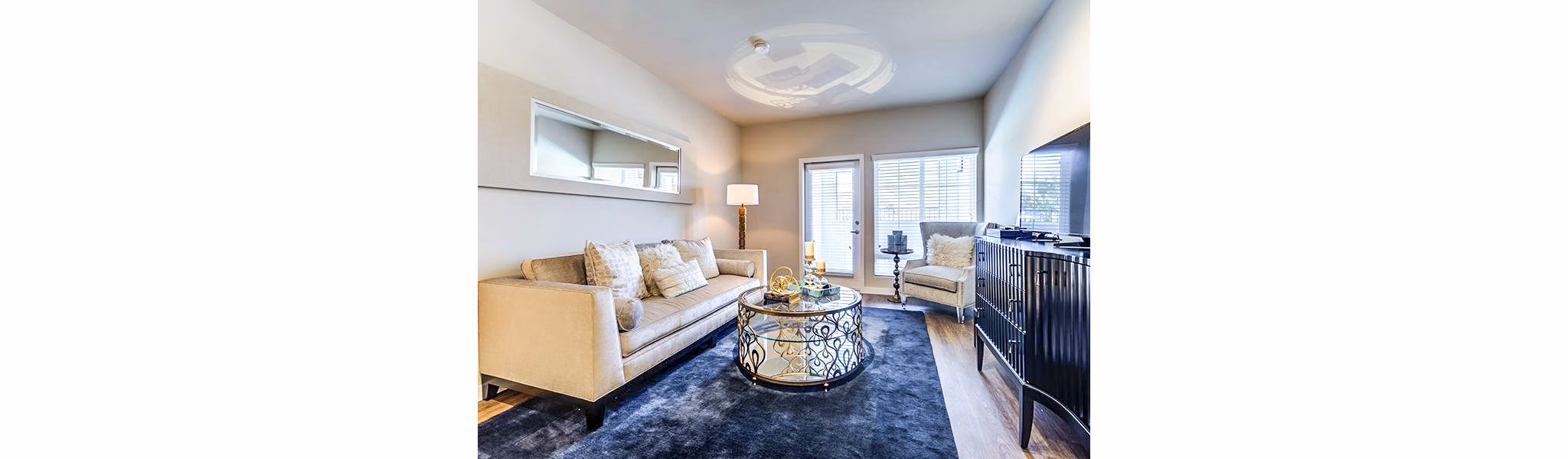 Elegant living room with modern decor and abundant natural light at Sereno Apartments, a Greystar luxury property