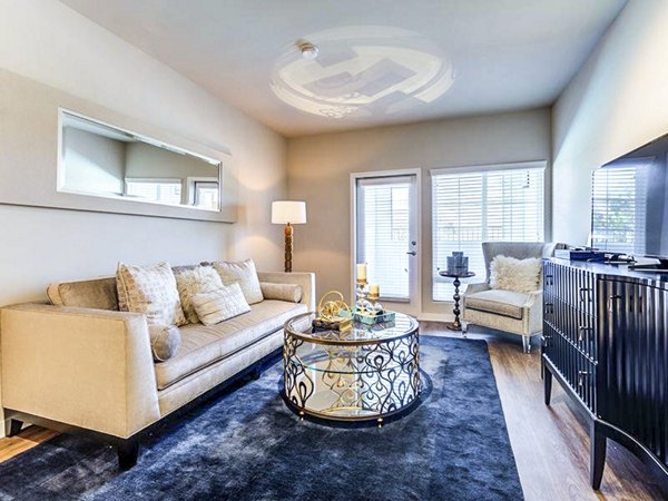 Elegant living room with modern decor and abundant natural light at Sereno Apartments, a Greystar luxury property