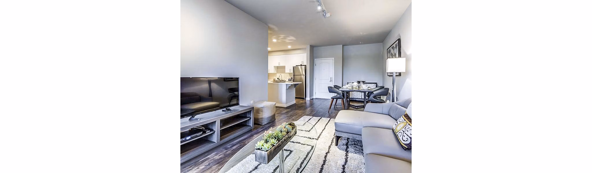 Spacious living room with modern furnishings in Sereno Apartments