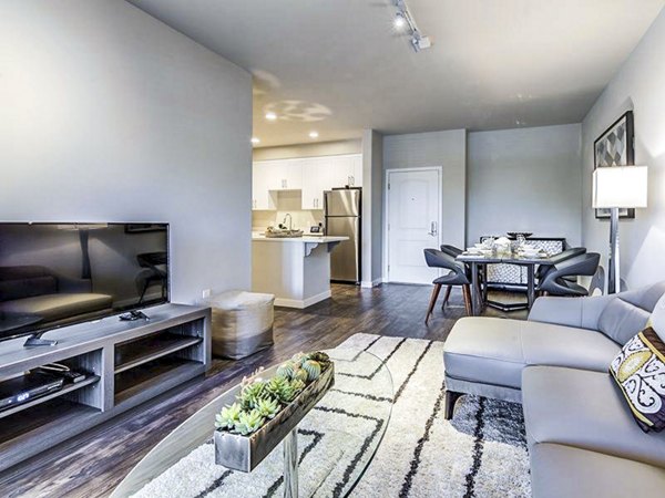 Spacious living room with modern furnishings in Sereno Apartments