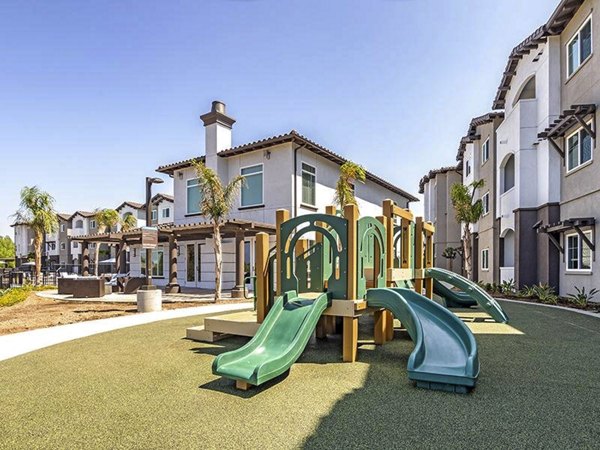 Playground with modern equipment at Sereno Apartments, providing a fun and safe outdoor space for children and families to enjoy