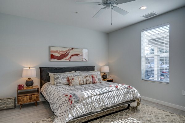 Cozy bedroom with modern decor at FLATZ 602 Apartments featuring luxury bedding, enhancing comfort and style
