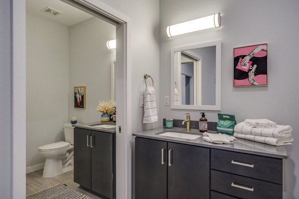 Modern bathroom featuring sleek fixtures and elegant tile work at FLATZ 602 Apartments, offering luxury living spaces