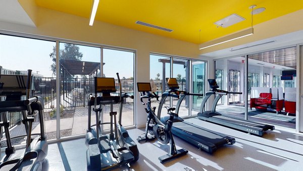 Modern fitness center with state-of-the-art equipment at FLATZ 602 Apartments, offering convenient workout options for residents
