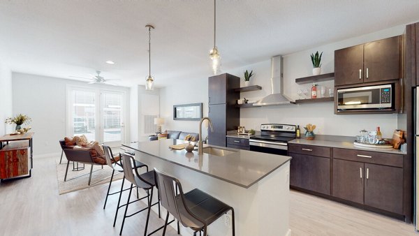 Modern kitchen with stainless steel appliances at FLATZ 602 Apartments