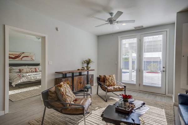 Living room with modern decor and large windows at FLATZ 602 Apartments in a Greystar luxury community
