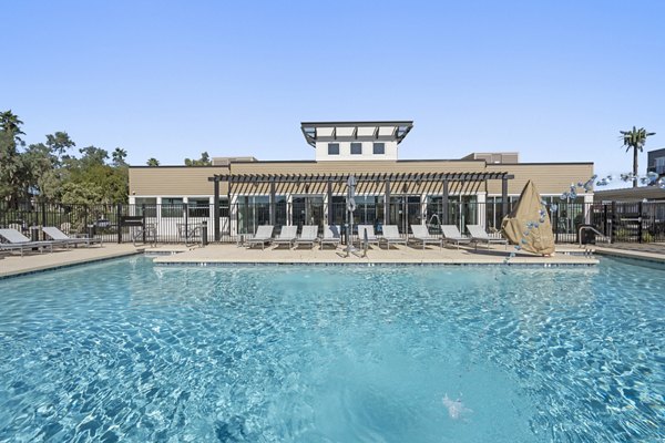 Relaxing outdoor pool area with sun loungers at FLATZ 602 Apartments, Greystar luxury apartments