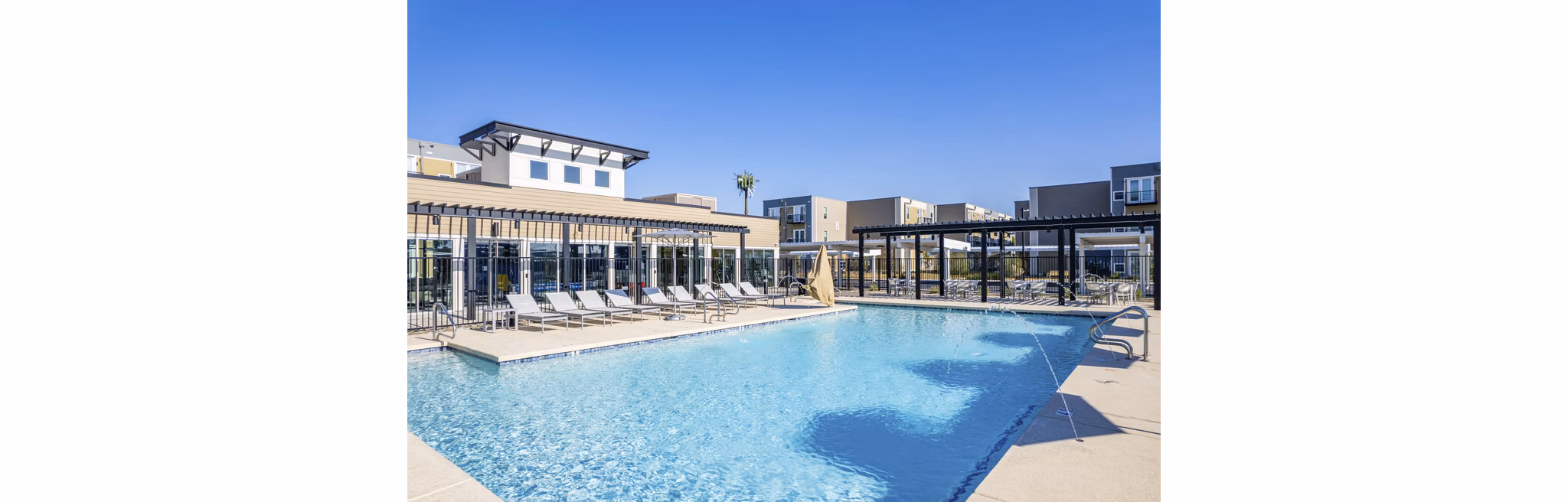 Modern pool with sun loungers at FLATZ 602 Apartments, luxury living by Greystar