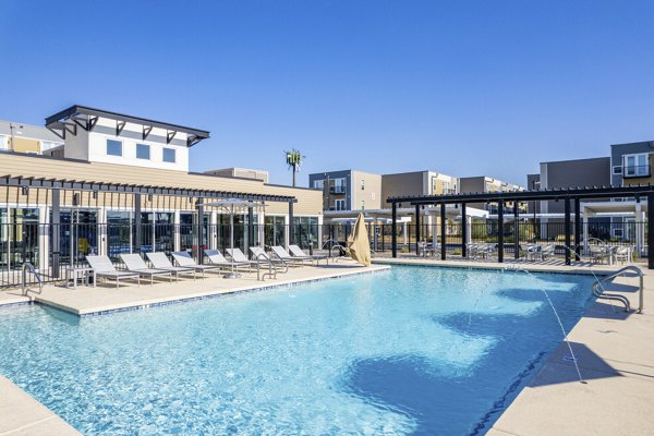Modern pool with sun loungers at FLATZ 602 Apartments, luxury living by Greystar