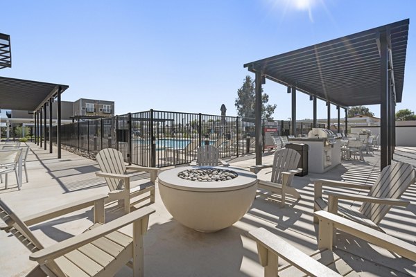 Fire pit with cozy seating area at FLATZ 602 Apartments offering outdoor relaxation space