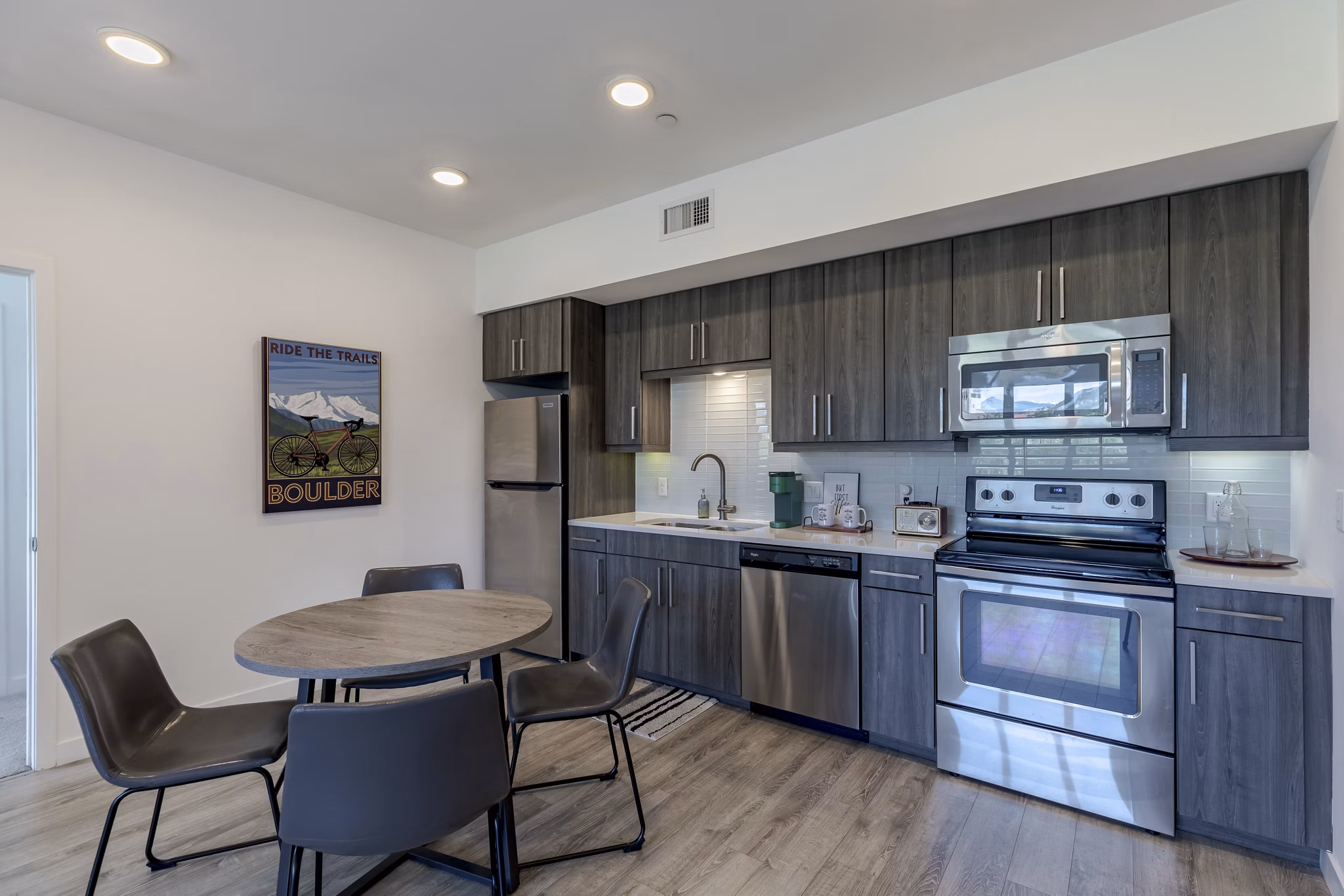 Contemporary kitchen with sleek cabinets and stainless steel appliances at Union 9Seventy Apartments