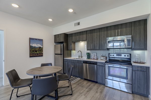 Contemporary kitchen with sleek cabinets and stainless steel appliances at Union 9Seventy Apartments