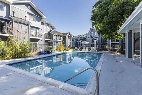 Resort-style outdoor pool at Union Baseline Apartments featuring lounge chairs and landscaped surroundings