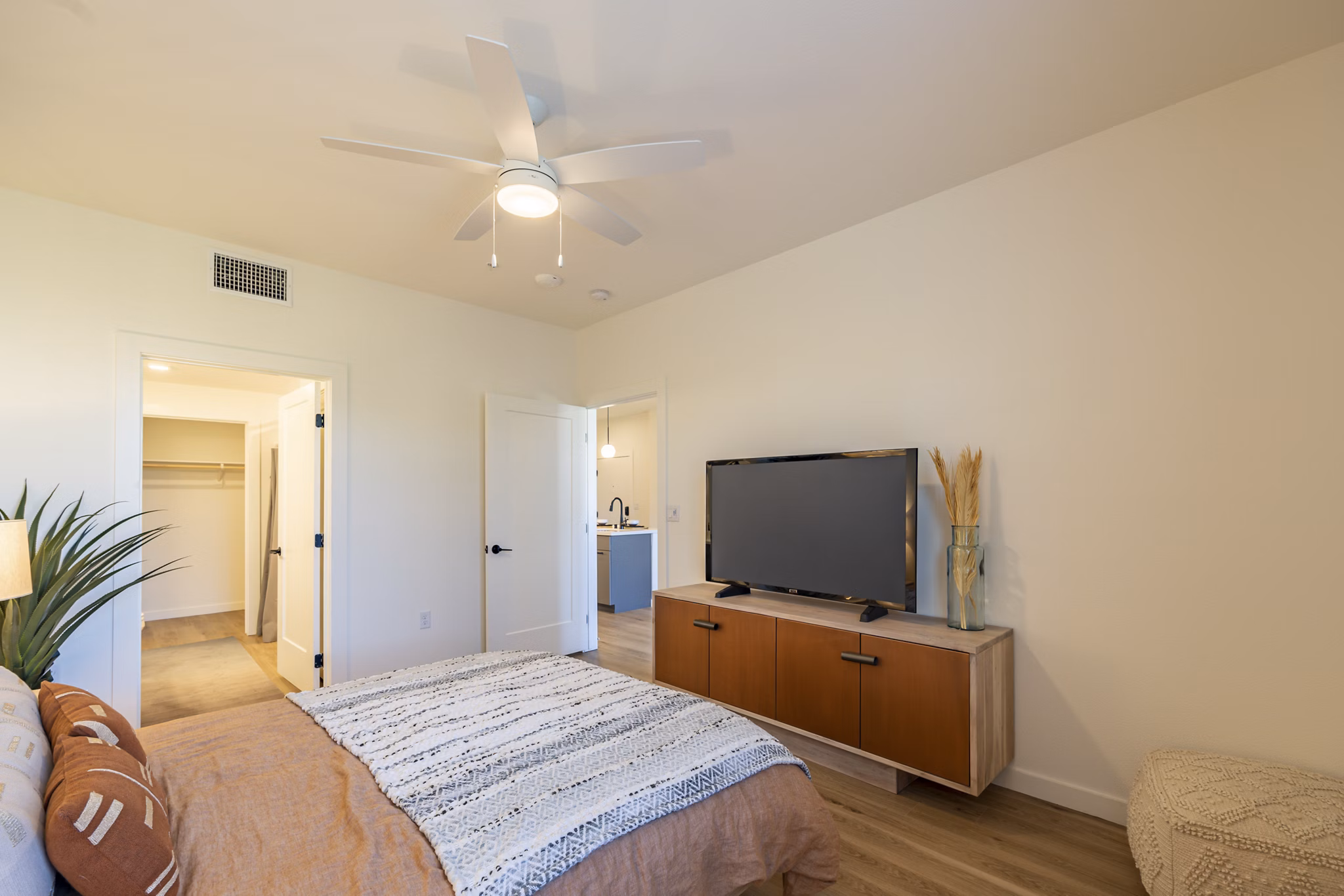 Cozy bedroom with neutral tones and large window at Alma Apartments