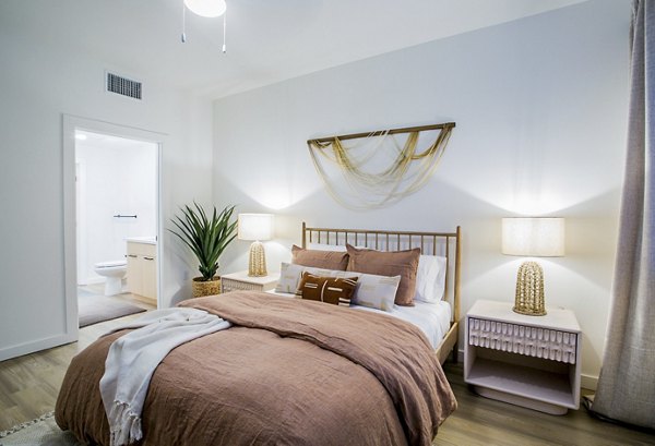 Cozy bedroom with modern decor at Alma Apartments